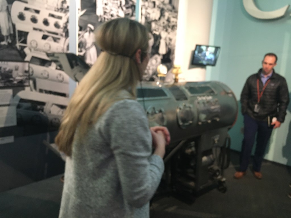 A group of people standing in a room

Description automatically generated