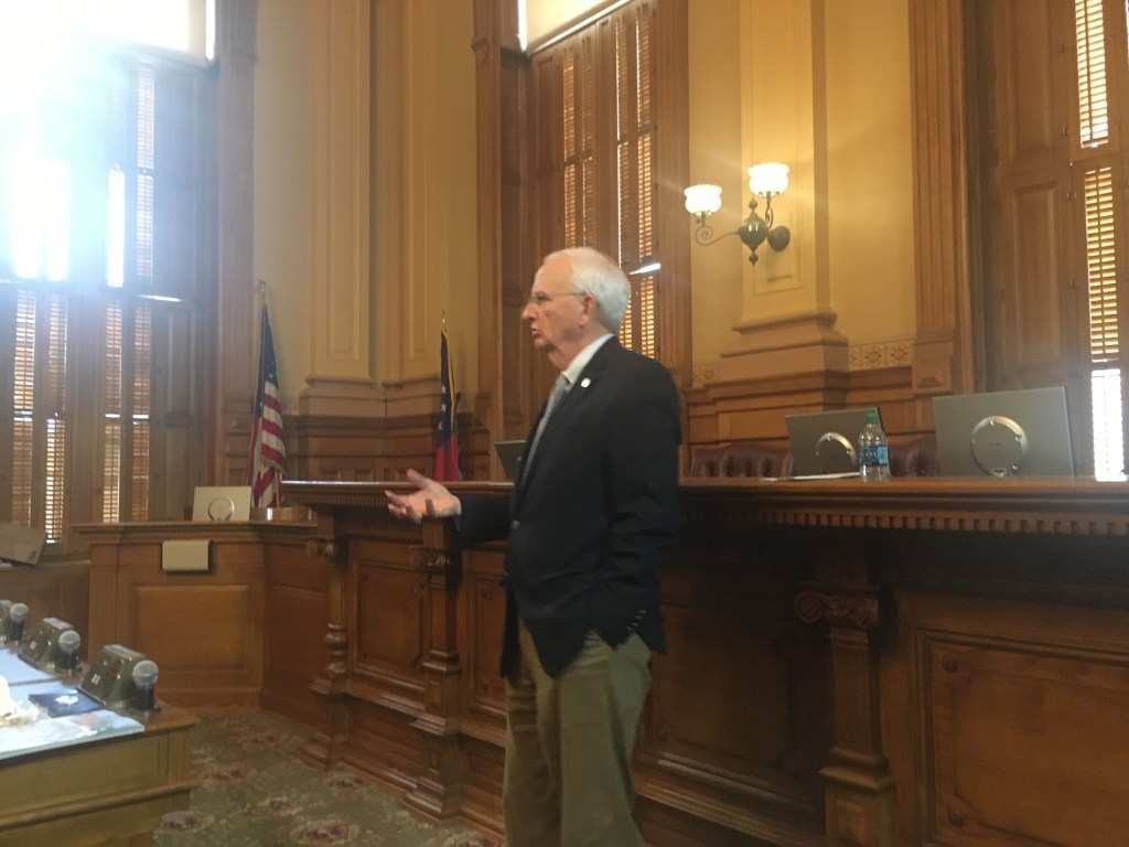 A person standing in front of a window

Description automatically generated